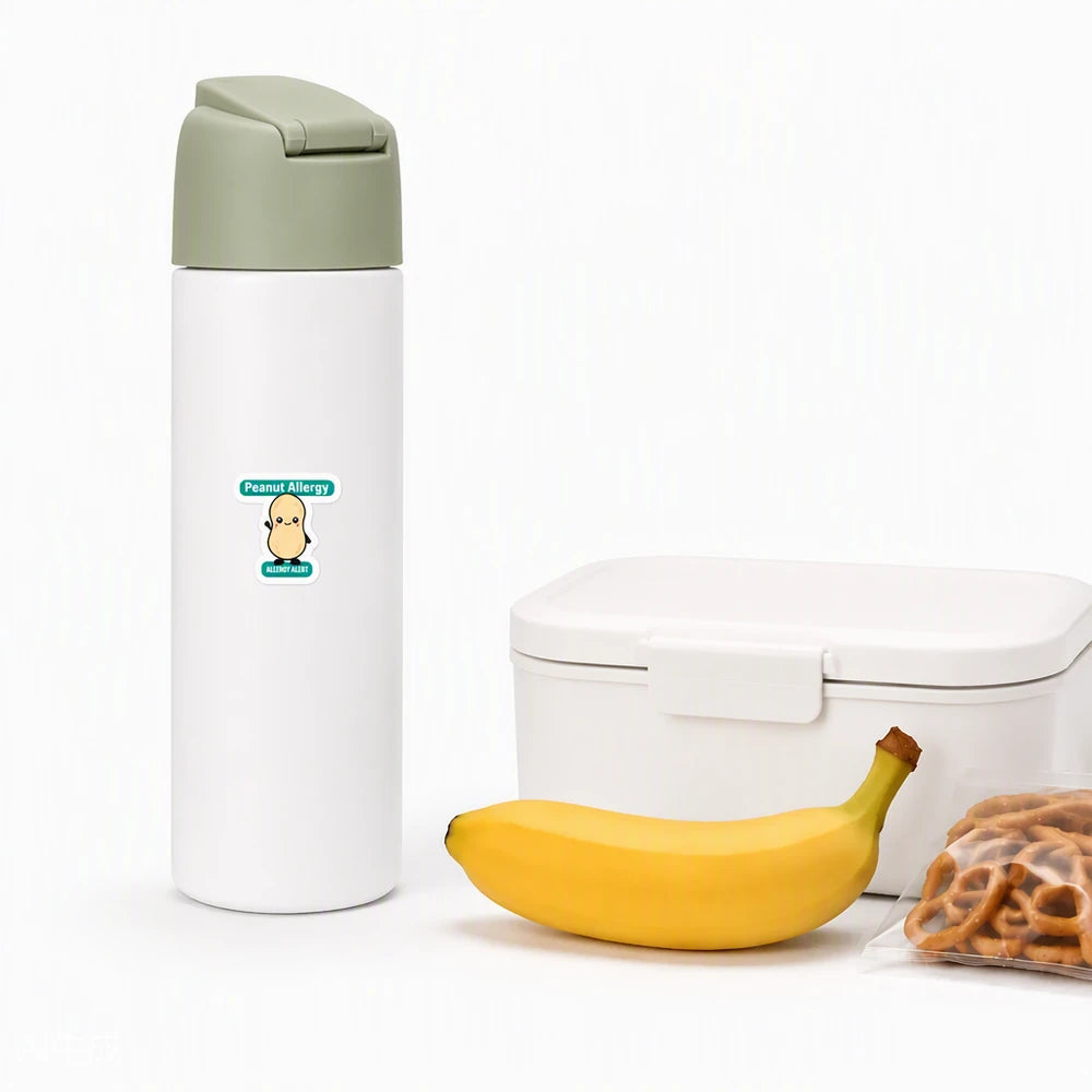 A cartoon peanut allergy alert sticker on a white water bottle, providing a clear peanut allergy reminder for teachers, caregivers, and school lunch staff.